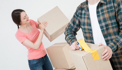 Operatives using safe lifting techniques during a move