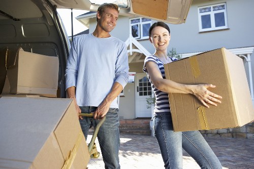 Movers handling office furniture and equipment carefully during relocation