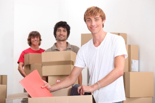 Packed boxes and furniture being loaded into a van