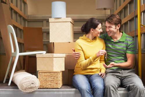 Local moving team organising boxes and belongings in Roehampton